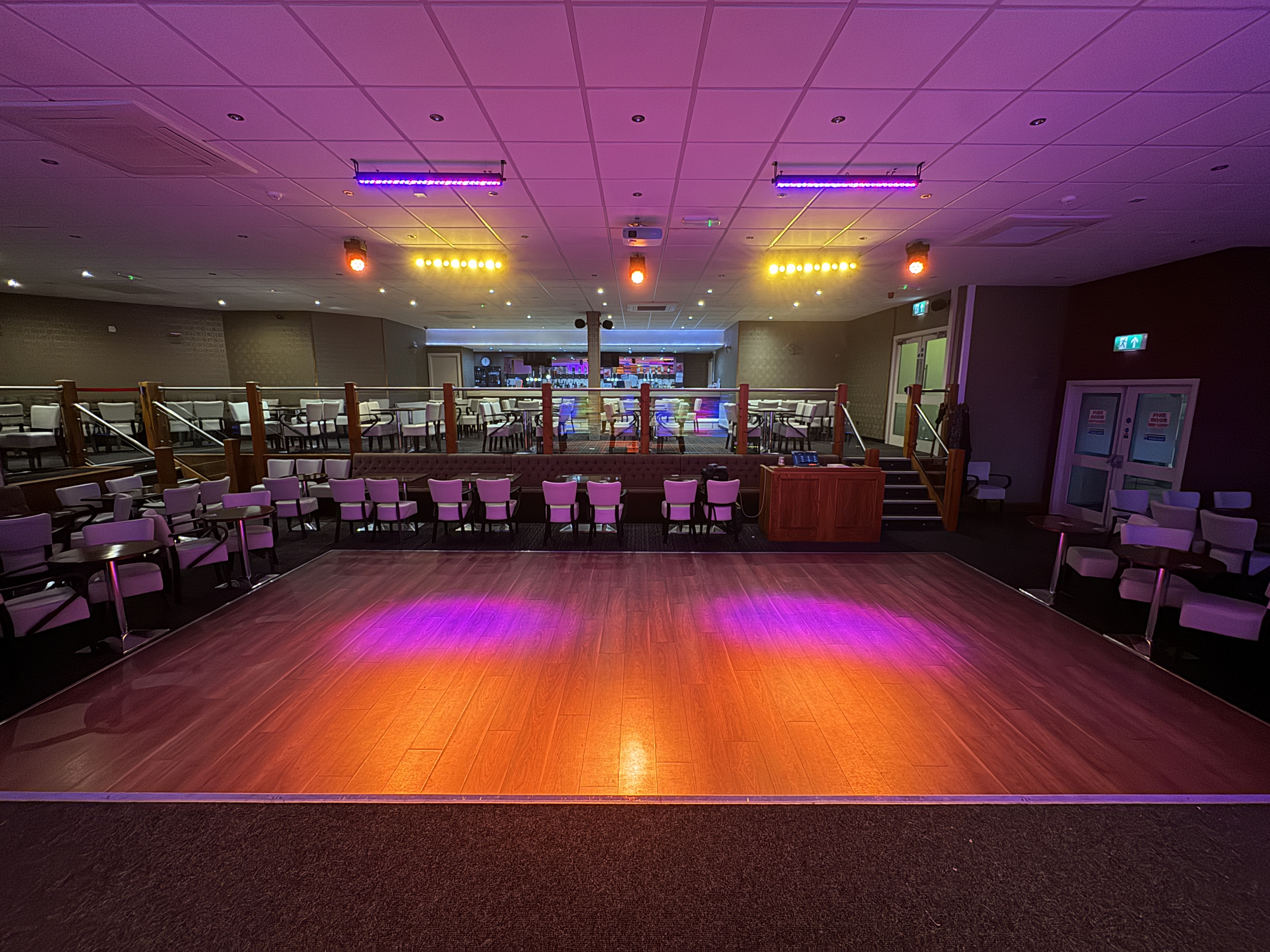 Three Stairville SonicPulse wash moving heads creating dynamic colour sweeps across the dance floor